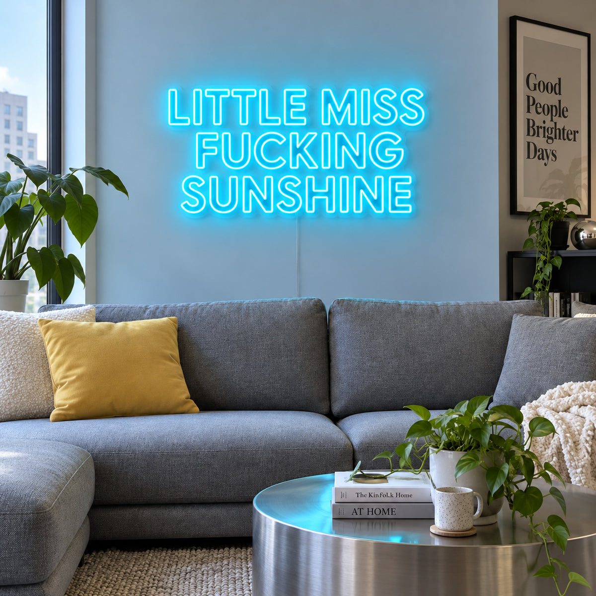 Ice Blue version of the Little Miss Fucking Sunshine Neon Sign, shown above a grey sofa with yellow cushions.