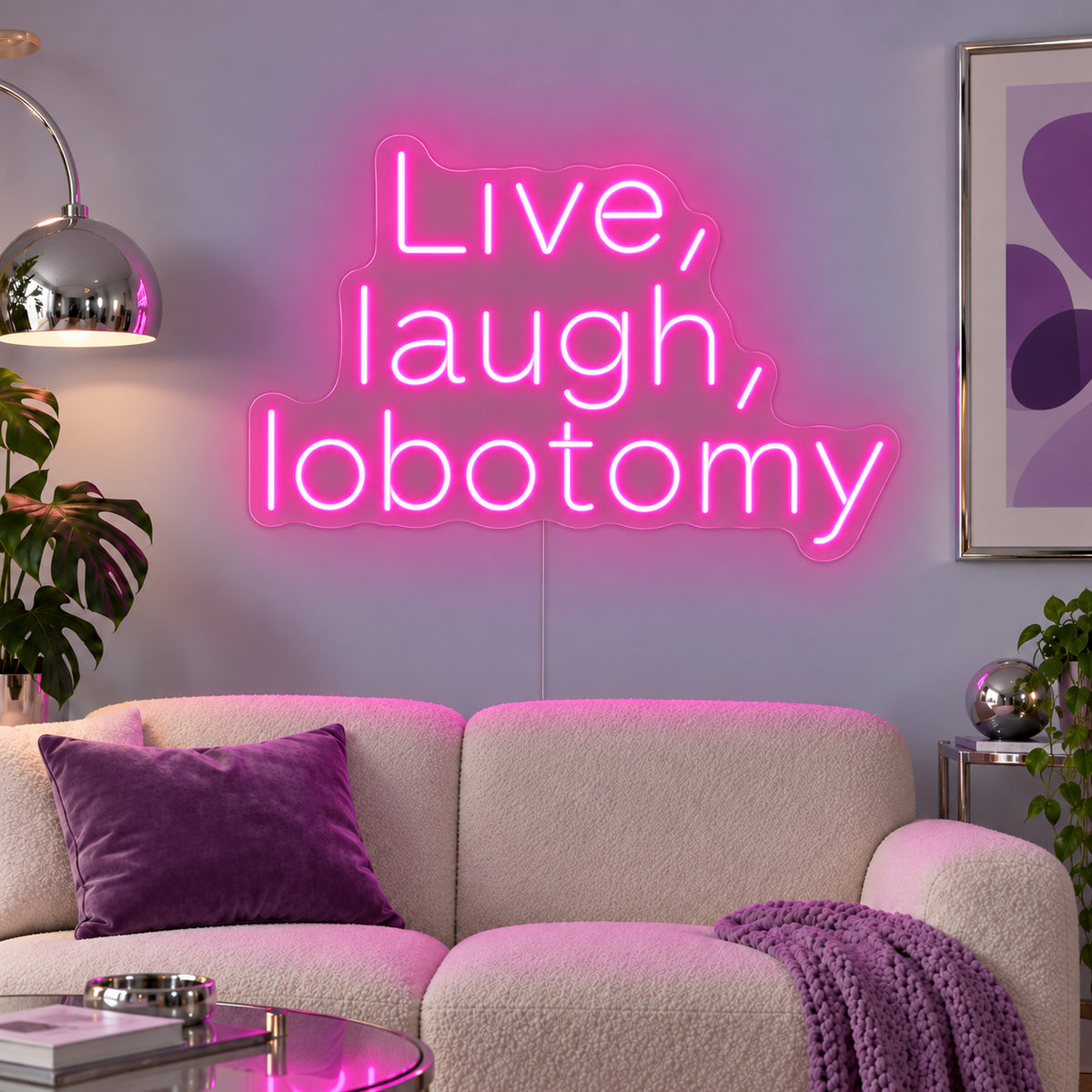 Rose Red version of the Live, Laugh, Lobotomy Neon Sign, shown above a cream sofa with purple cushions.