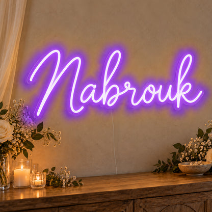 Mabrouk Neon Sign in purple LED neon on clear acrylic, angled view