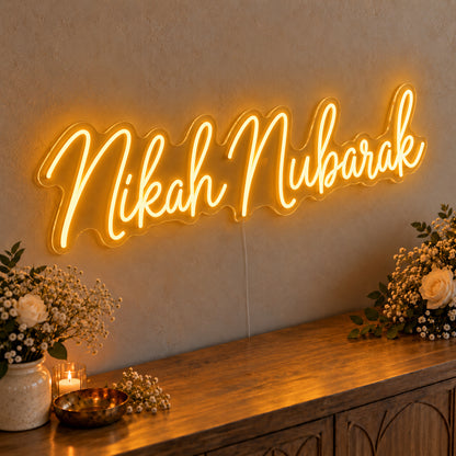 Nikah Mubarak Neon Sign in gold LED neon on clear acrylic, angled view