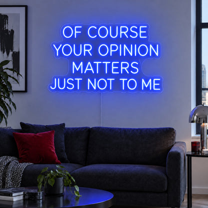 Of Course Your Opinion Matters Just Not To Me Neon Sign glowing blue above a black sofa.