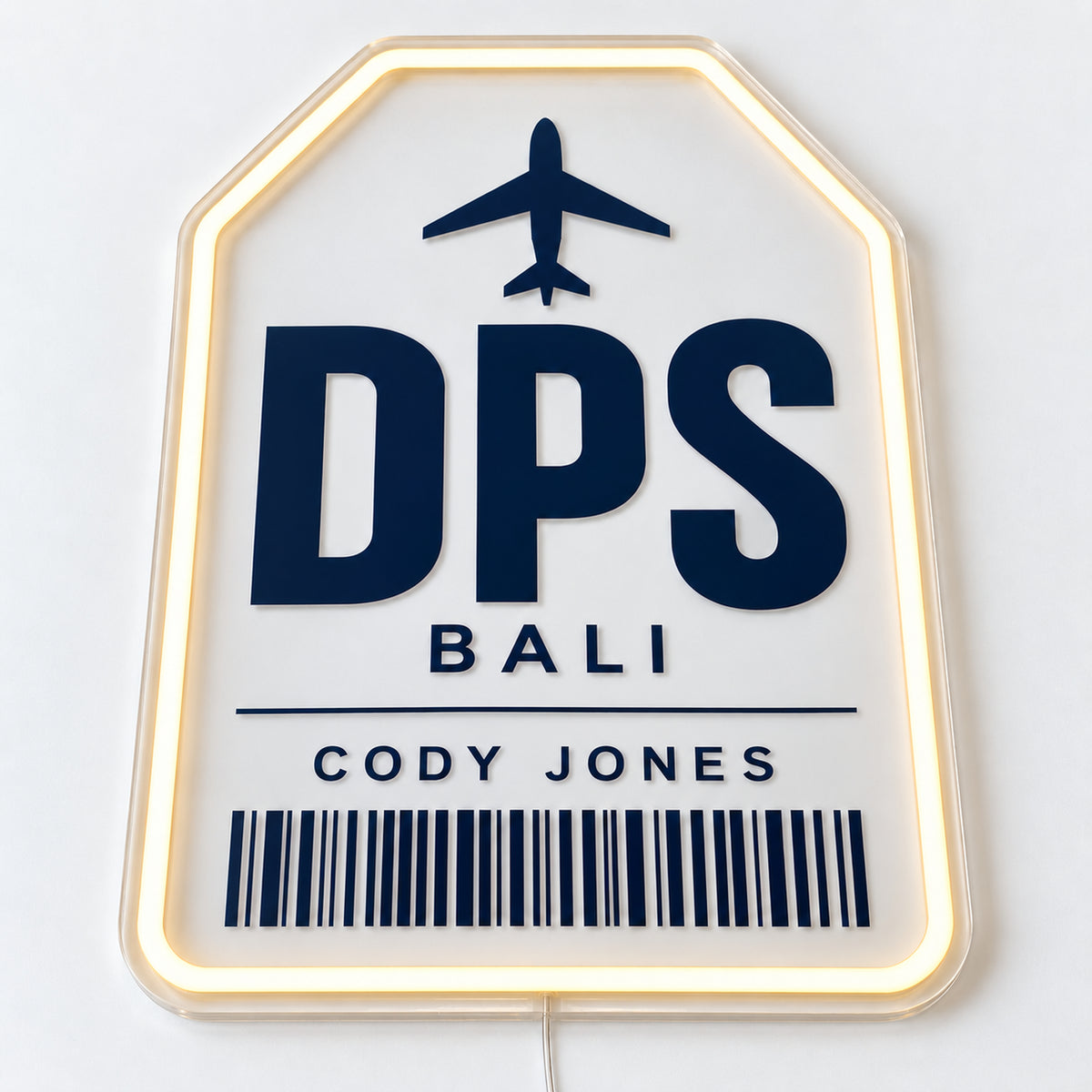 Personalised Baggage Tag Neon Sign, featuring a personalised baggage tag, shown with Cody Jones and DPS Bali, on a single clear acrylic backing displayed on a white surface.