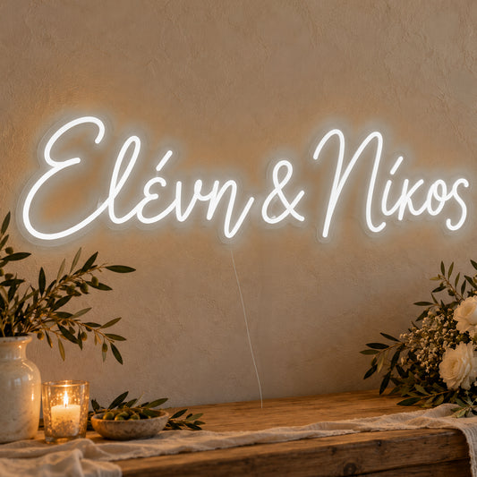 Personalised Greek Couple Names Neon Sign in white LED neon on clear acrylic, angled view