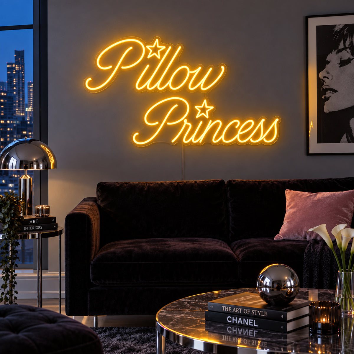 Pillow Princess Neon Sign glowing gold with star details above a dark purple sofa.