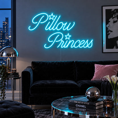 Ice Blue version of the Pillow Princess Neon Sign, shown with star details above a dark purple sofa.