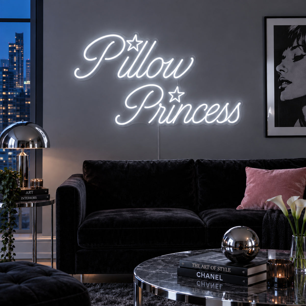 Pillow Princess Neon Sign glowing white with star details above a dark purple sofa.