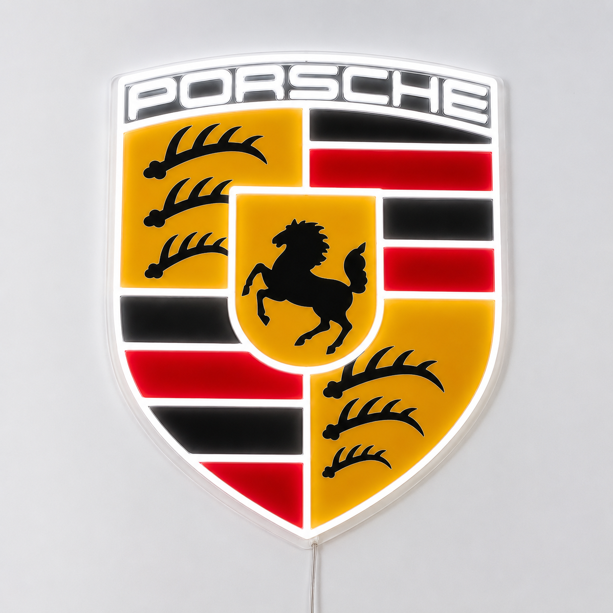 Porsche crest LED neon sign in full colour glowing on a white wall