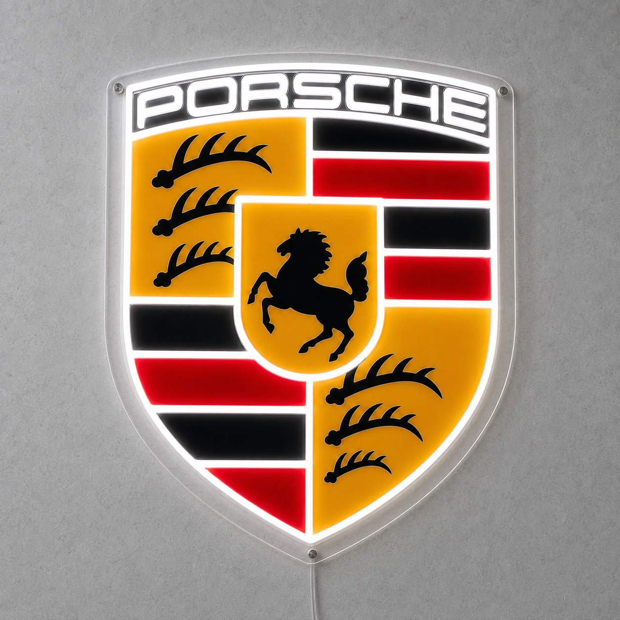 Porsche crest LED neon sign in full colour mounted on a grey wall with white glow
