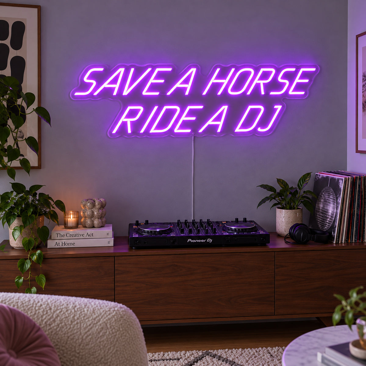Save A Horse Ride A DJ Neon Sign with purple lighting, displayed above a turntable on a wooden sideboard.
