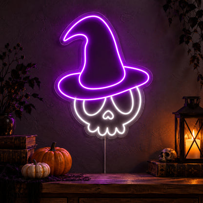 Skull with Witch Hat Neon Sign featuring a white skull wearing a tall purple witch hat, glowing on a dark wall in a Halloween room display.