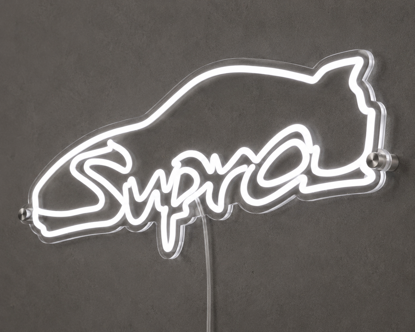 Angled close-up of Supra script neon sign glowing white