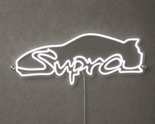 Supra Toyota inspired LED neon sign with white script lettering and car outline on a concrete wall
