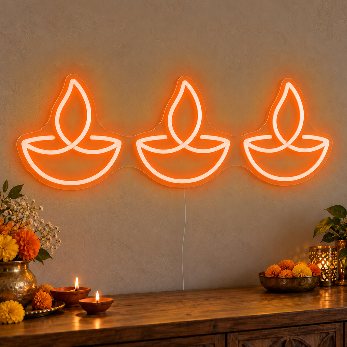 Three Diyas Neon Sign in orange LED neon on clear acrylic, angled view