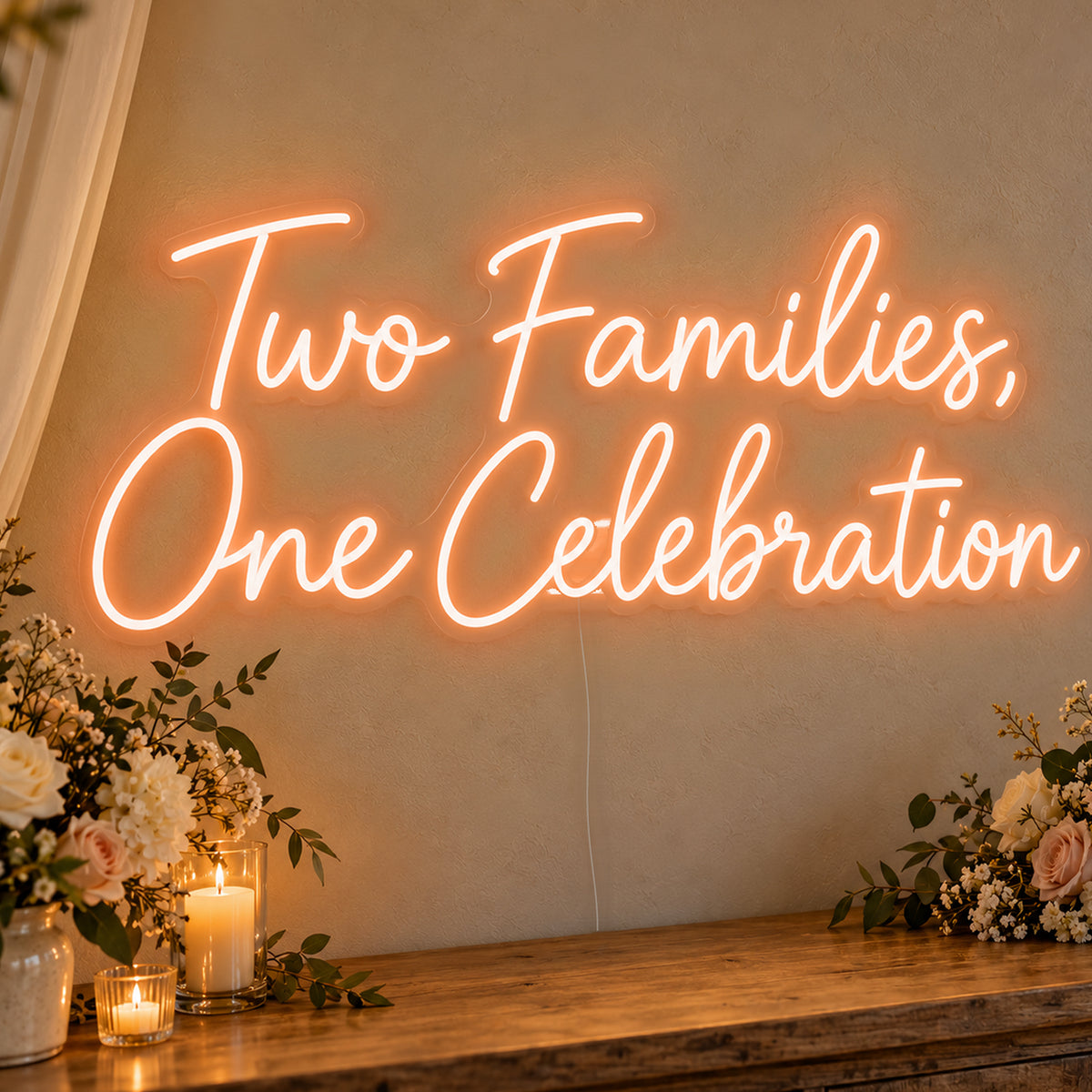 Two Families One Celebration Neon Sign in orange LED neon on clear acrylic, angled view